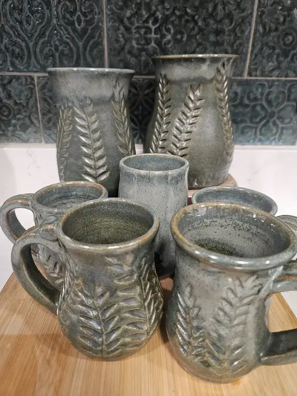 Oribe Botanical Collection mugs and vases with carved fern leaf patterns